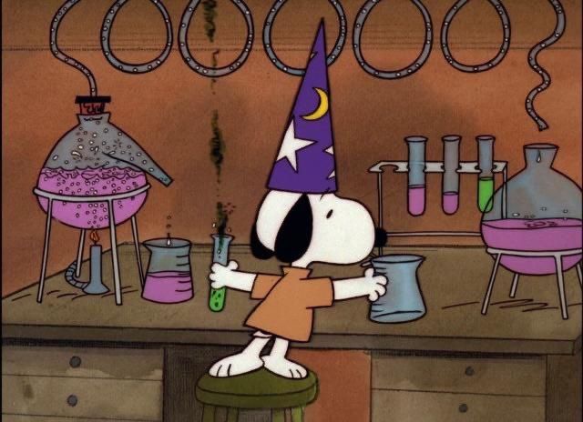 a cartoon dog wearing a party hat and holding a beaker in front of some laboratory equipment