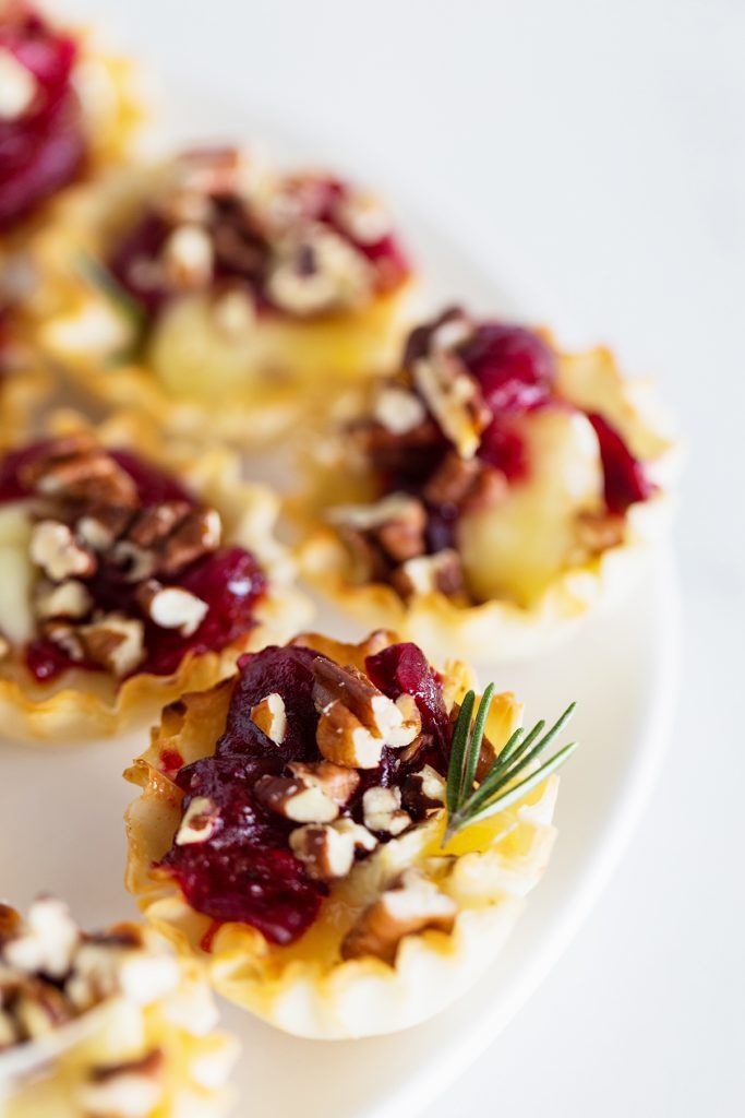 small appetizers with nuts and cranberry sauce on a white plate