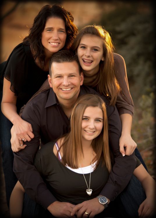 a family is posing for a photo together