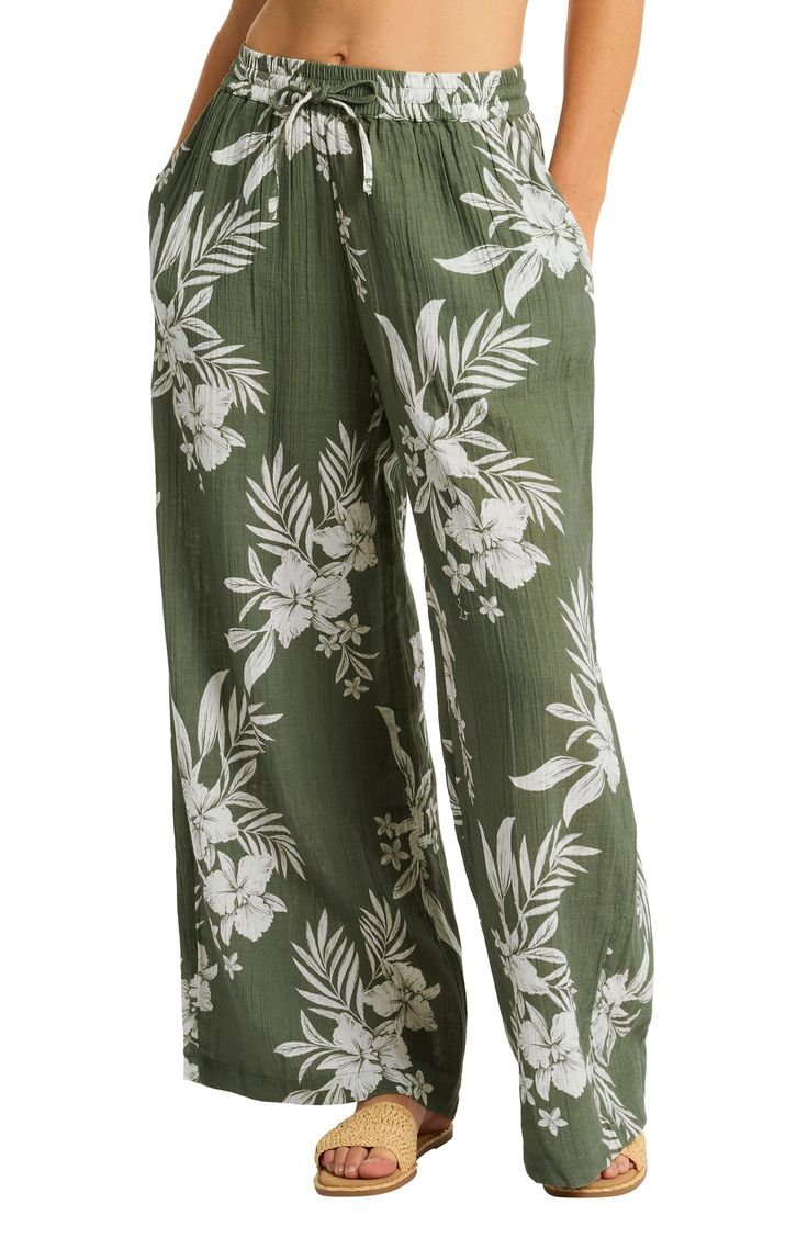 Cover up after a dip in these breezy wide-leg pants designed in a vacation-perfect tropical print. Elastic/drawstring waist Side-seam pockets 100% cotton Hand wash, dry flat Imported Floral Print Wide Leg Pants For Summer Beach, Casual Printed Pants For Vacation, Summer Beach Wide Leg Pants With Floral Print, Floral Print Wide Leg Pants For Beach, Printed Cotton Bottoms For Vacation, Vacation Floral Print Wide-leg Pants, Floral Print Wide-leg Pants For Vacation, Printed Wide-leg Pants For Vacation, Cotton Printed Pants For Vacation