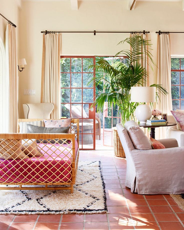 a living room filled with furniture next to a window covered in curtains and windowsills