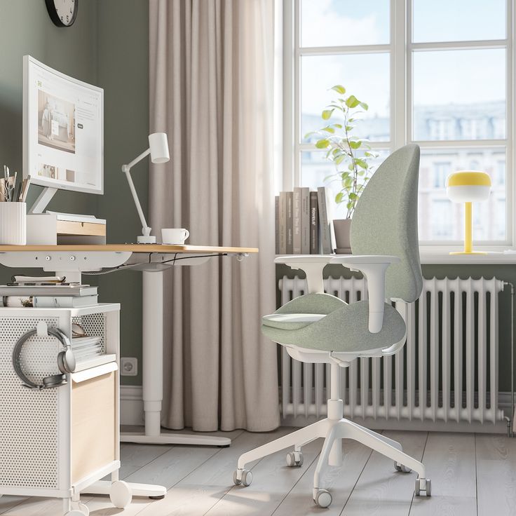 a red office chair sitting in front of a computer desk