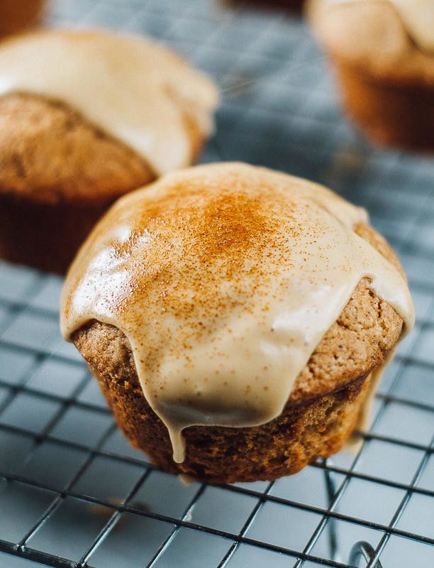 cinnamon muffins with icing on a cooling rack, ready to be eaten