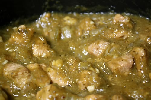 meat and vegetable stew in a black bowl