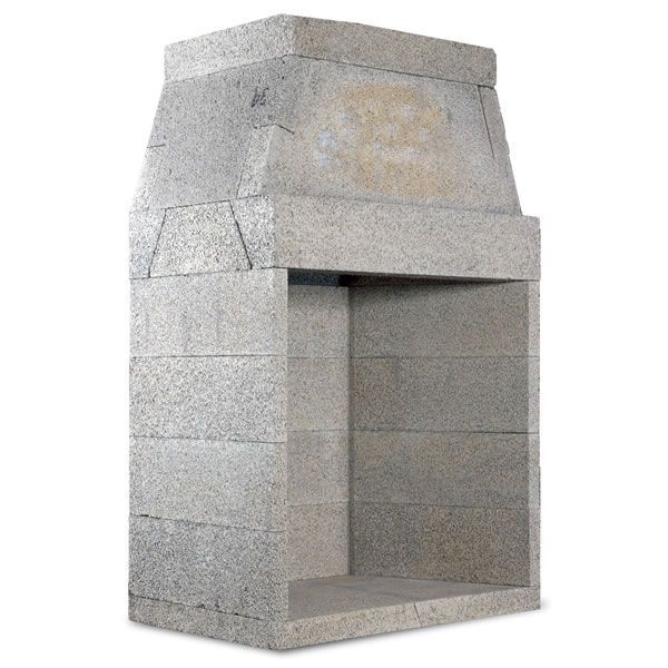 a cement fire place sitting on top of a white floor