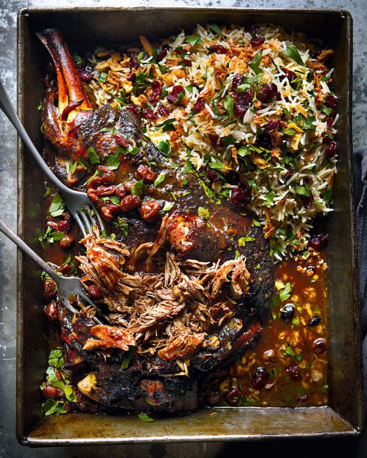 a roasting pan filled with shredded meat and vegetables