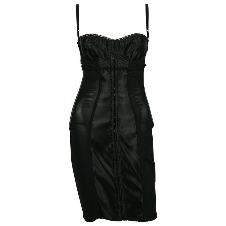 DOLCE & GABBANA black lingerie corset bustier dress. This sexy dress features : - Black mesh and heavy satin. - Stretchy. - Fitted knee-length. - Satin bra topped with lace detail. - Whalebones. - Spaghetti straps. - Hook & eye fastening at the front. Label reads DOLCE & GABBANA Made in Italy. Size tag reads : 38. Photographied on a XS mannequin (size FR 36). Please check measurements. Composition label reads : 81 % Nylon / 19 % Elastane. Indicative measurements taken laid flat and unstretched ( Fashion Dresses Black, Black Cocktail Dresses, Dresses Fitted, Dresses Corset, Knee Length Cocktail Dress, Cocktail Dress Vintage, Vintage Corset, Corset Bustier, Bustier Dress