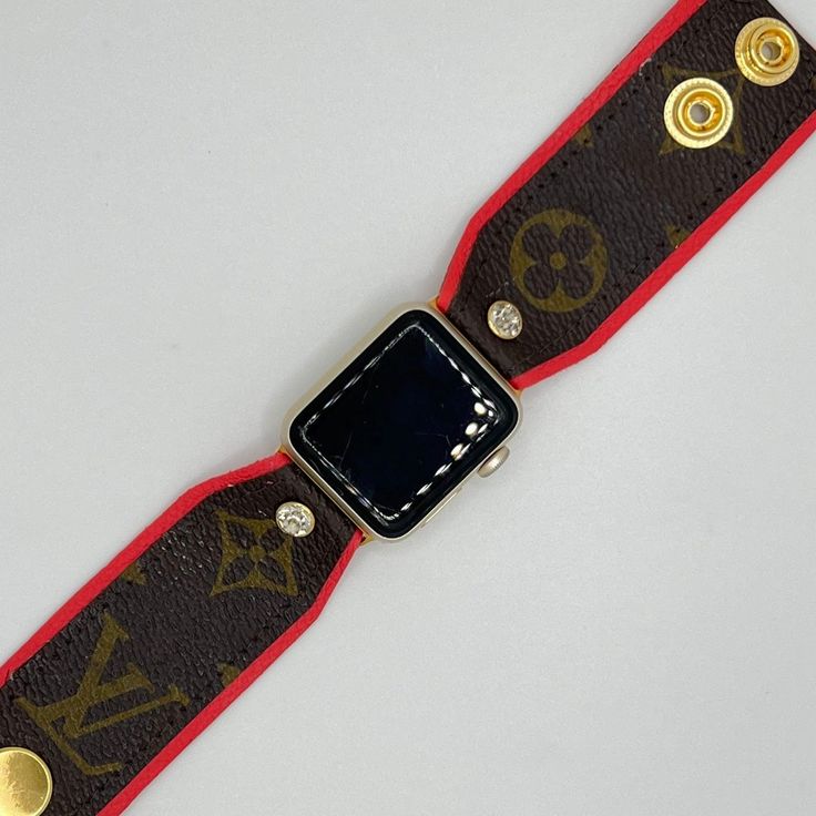 Introducing the "Elle," our latest addition to the collection, is a hand-crafted watchband made with bright coral leather that features the classic brown monogram LV from a repurposed bag, giving it a unique and stylish look. The band is designed to securely fit your Apple Watch, with gold fitting connectors that ensure a perfect fit. For your comfort and convenience, we have added two gold high-quality snaps, allowing you to adjust the size of the band to your liking and ensuring a comfortable Designer Leather Bracelets, Designer Gold Leather Watch Accessories, Brown Rectangular Jewelry, Trendy Gold Leather Apple Watch Band, Designer Brown Adjustable Bracelet, Luxury Brown Adjustable Bracelet, Luxury Gold Watch Bands With Leather Strap, Luxury Gold Leather Strap Watch Bands, Designer Adjustable Brown Bracelet