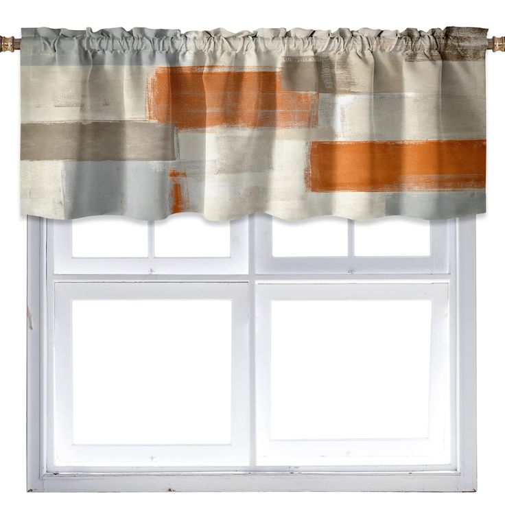 an orange and white curtain hanging on a window