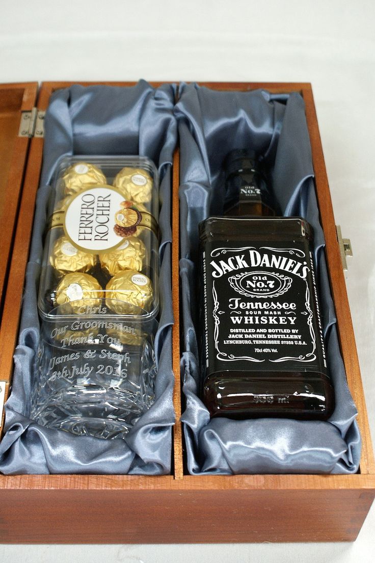 two bottles of jack daniels whiskey and chocolates in a wooden box with blue satin