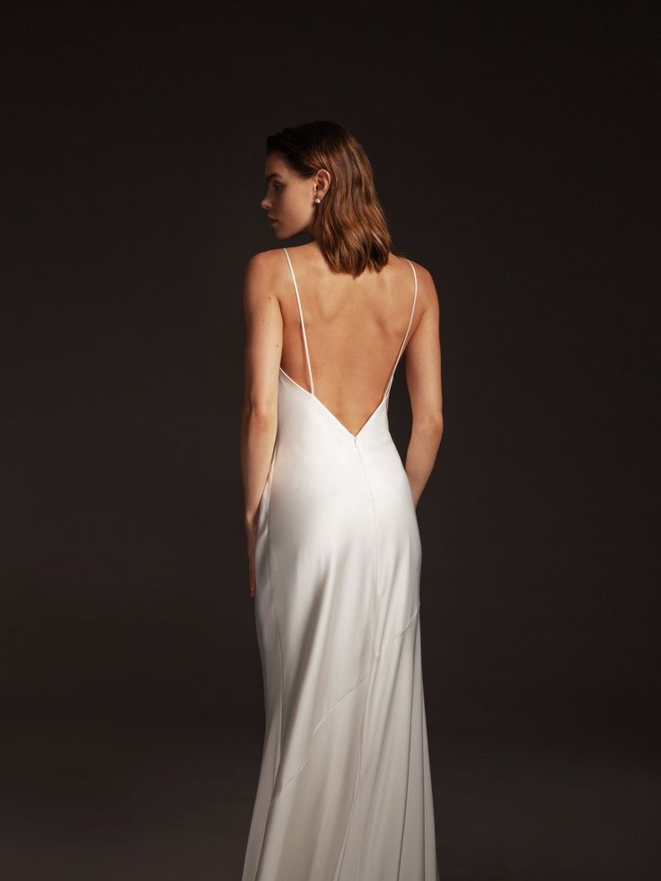 a woman in a white dress is looking back