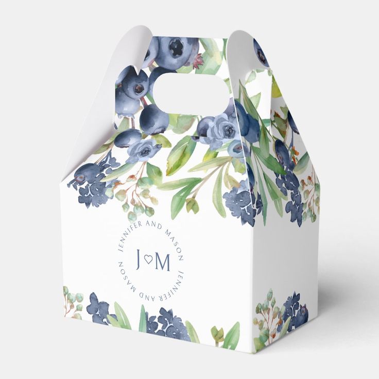 a white box with blue and green flowers on the front is shown in this image