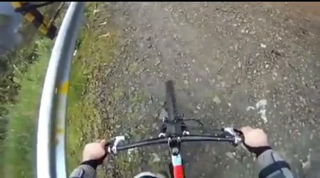 a person riding a bike down a dirt road