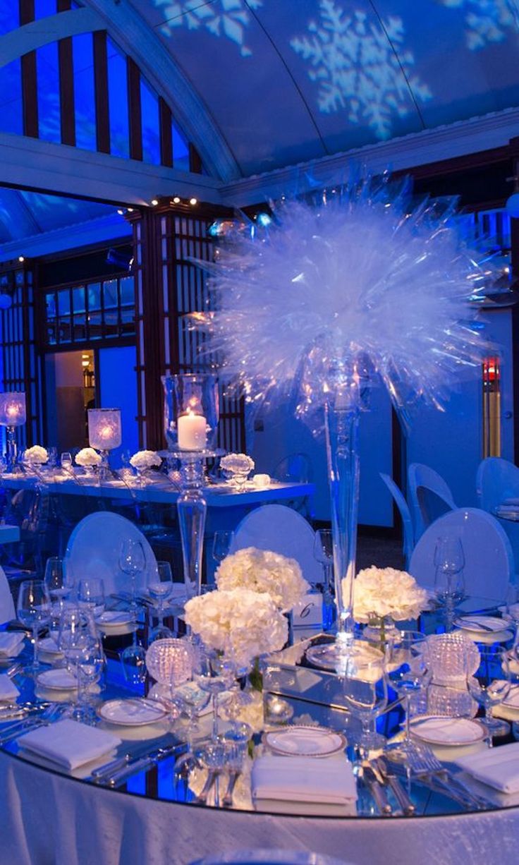 a table set up with white flowers and candles for a winter wedding reception at the four seasons hotel