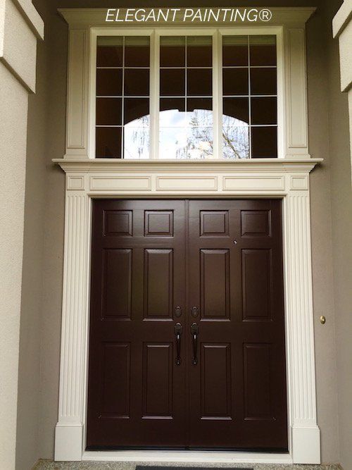 the front door to an elegant painting's office is painted in dark brown and white