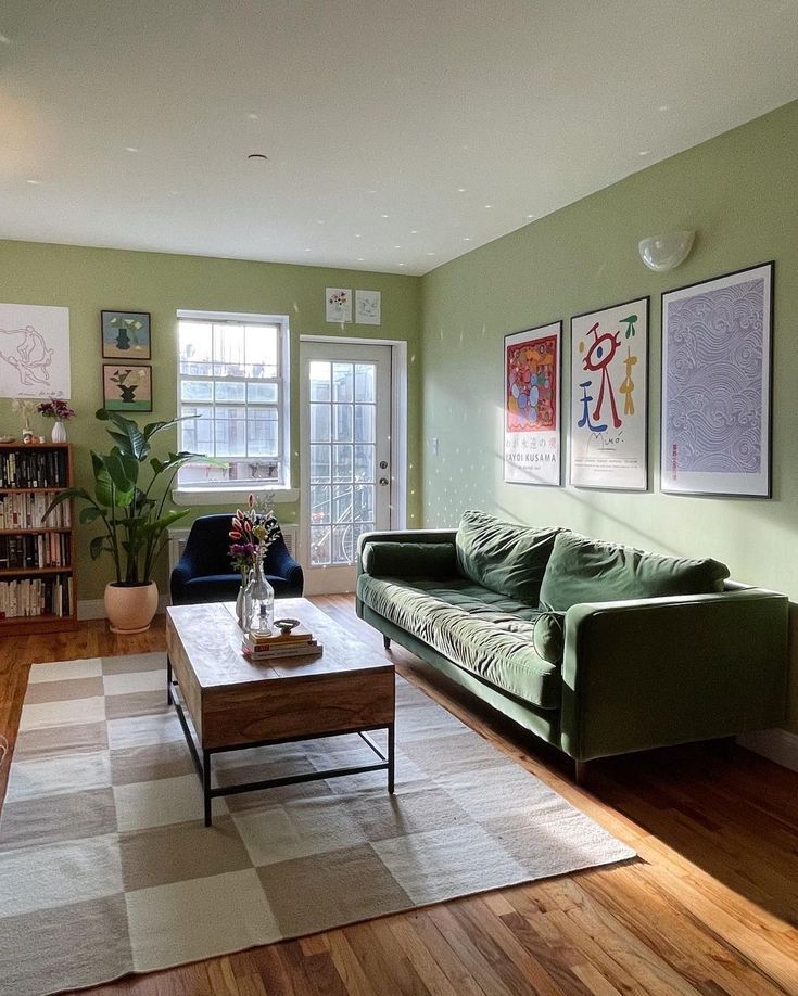 a living room filled with furniture and green walls