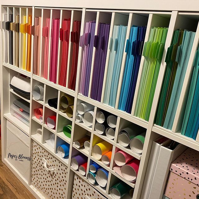 the shelves are filled with many different colored papers and paper straws in bins