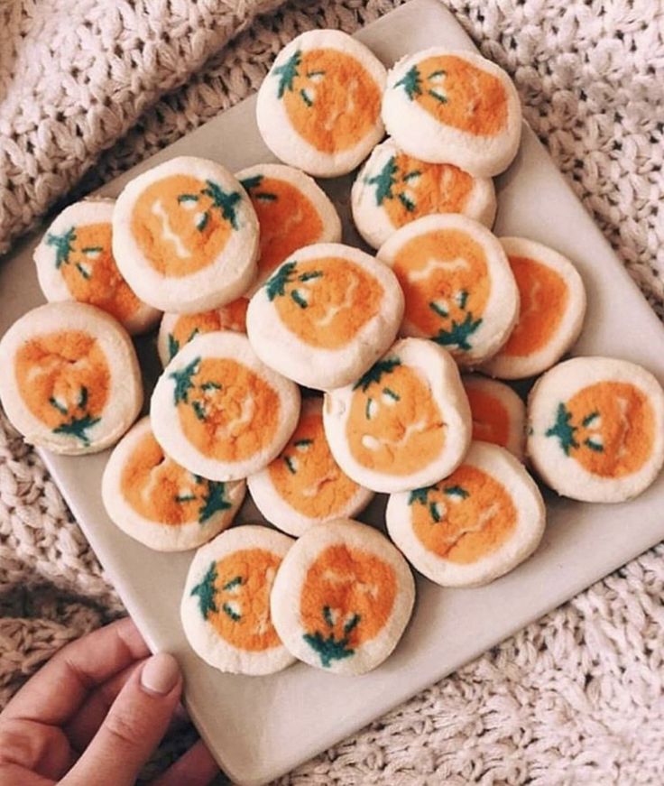 a person holding a plate full of deviled eggs