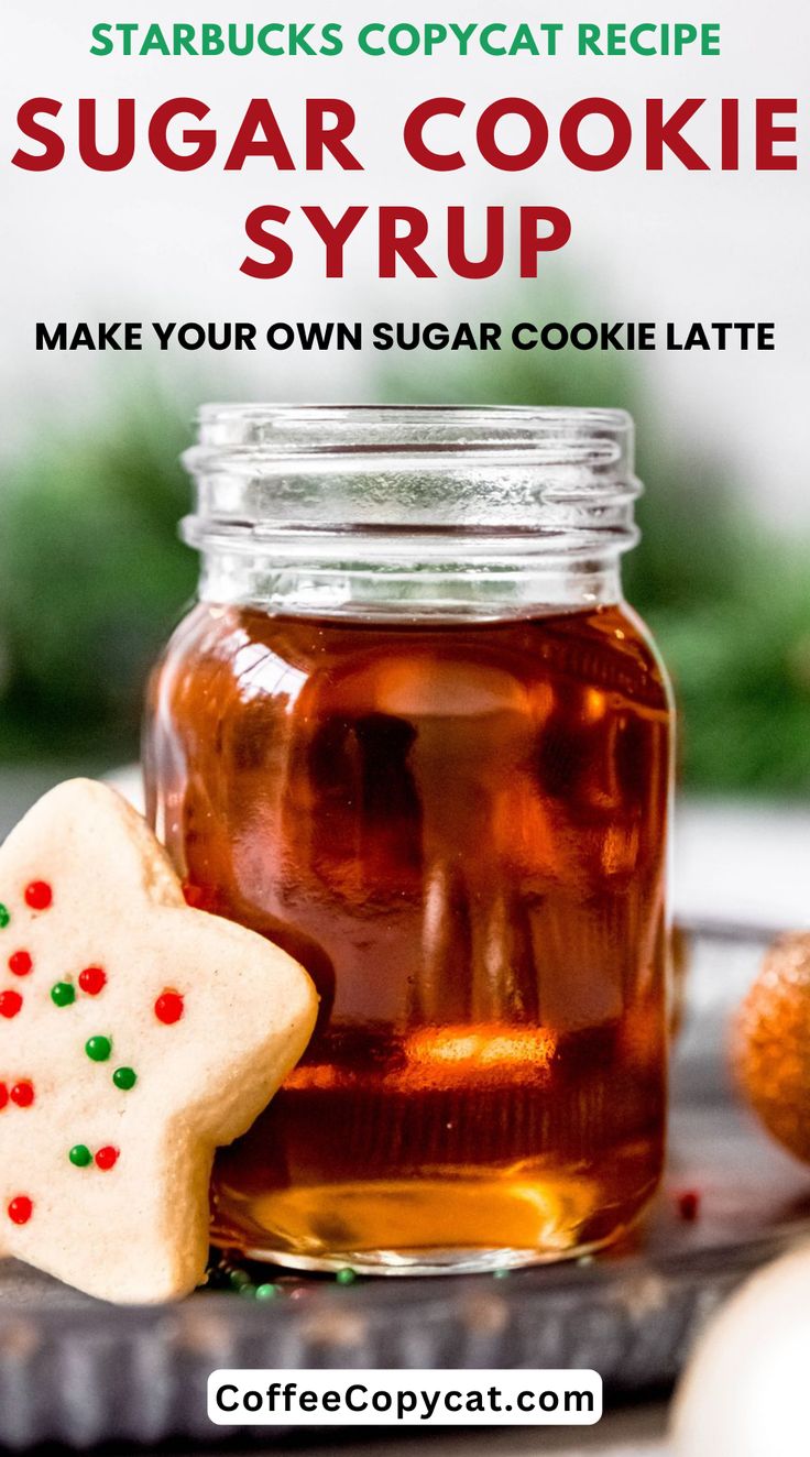 a jar of sugar cookie syrup next to some cookies on a plate with the words starbuck's copycat recipe sugar cookie