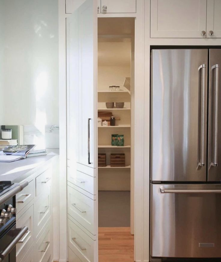 a stainless steel refrigerator freezer sitting inside of a kitchen