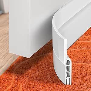 an orange area rug with a white door handle on the floor next to a wall