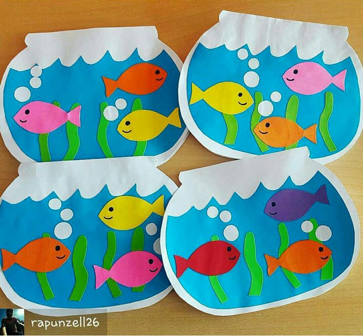 four paper plates with fish in the water and bubbles on them, sitting on a table