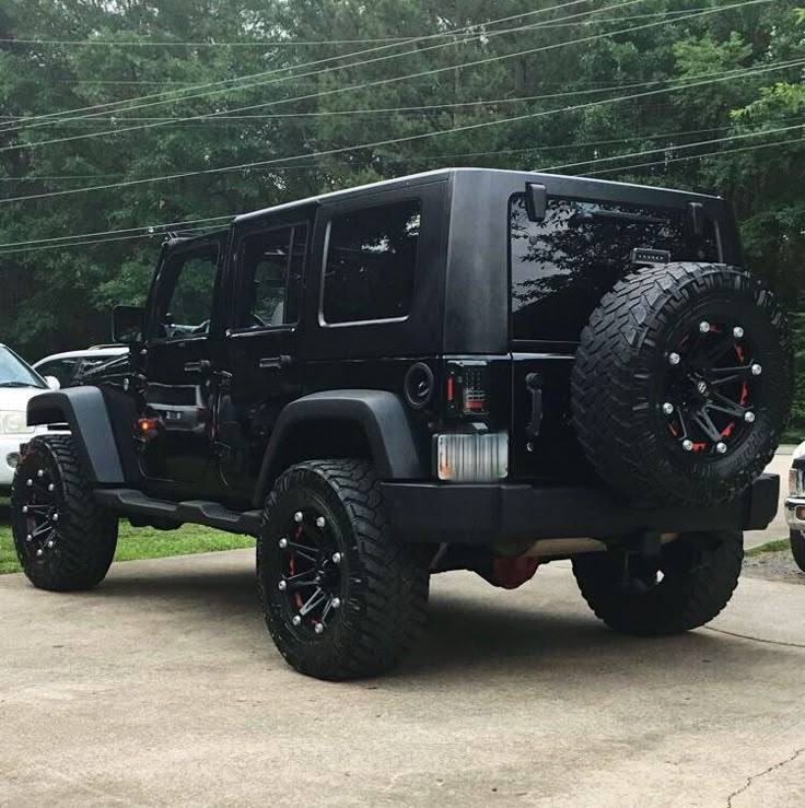 a black jeep is parked in the driveway