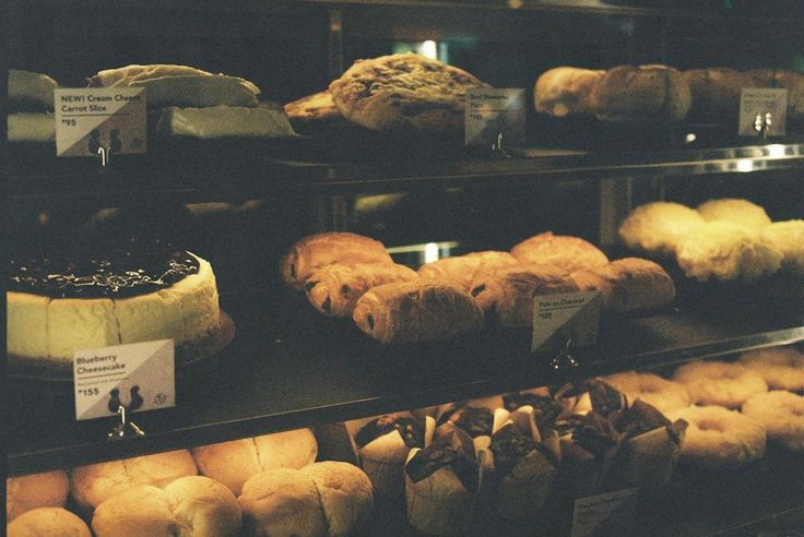 an assortment of baked goods on display in a bakery