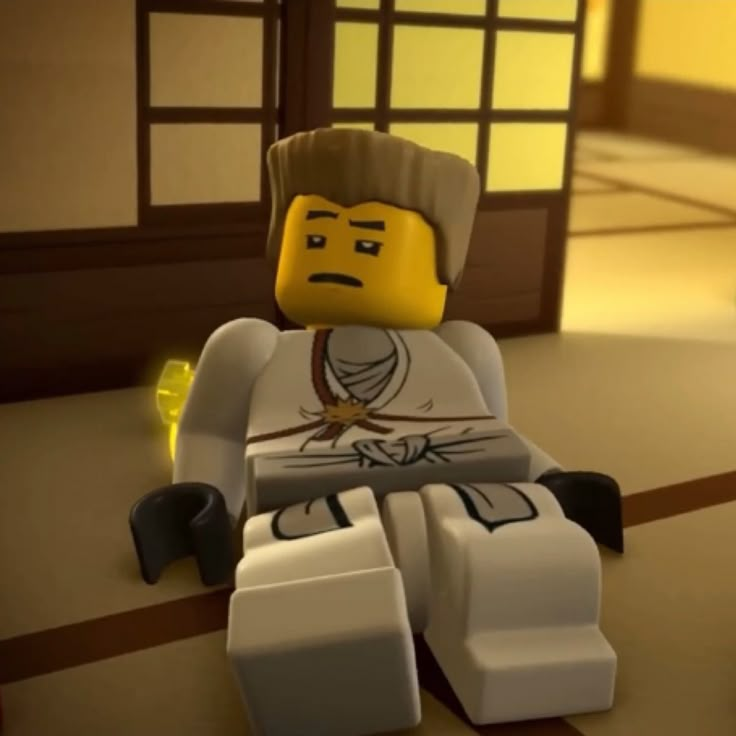 a lego man is sitting on the floor