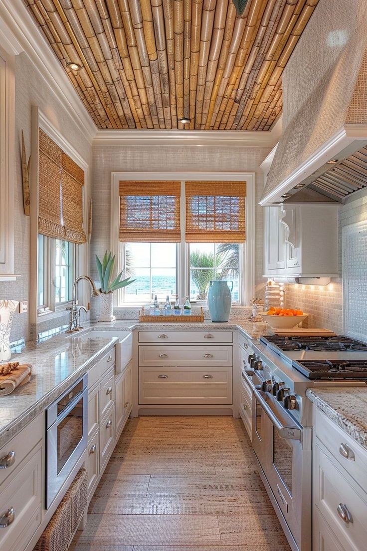 a kitchen with white cabinets and wooden ceilinging, along with bamboo shades on the windows