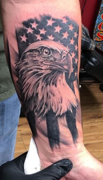 an eagle with the american flag on his arm