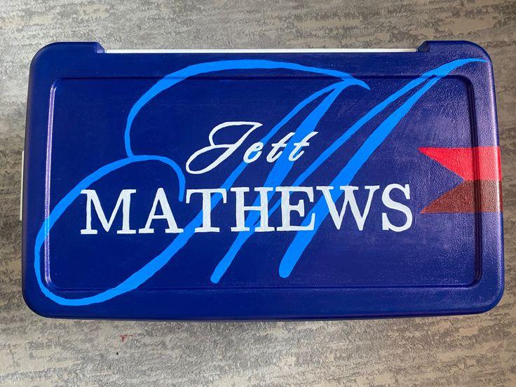 a blue tray with the words lett mathews on it and an arrow