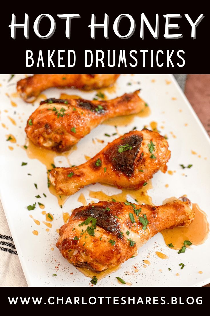 baked drumsticks on a white plate with the words hot honey baked drumsticks