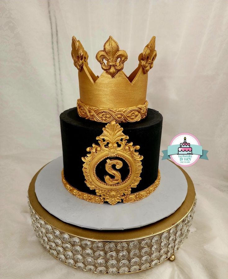 a black and gold cake with a crown on top