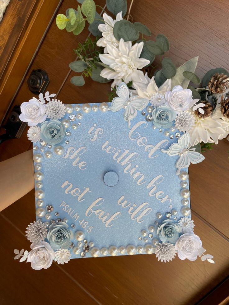 a blue and white graduation cap with flowers