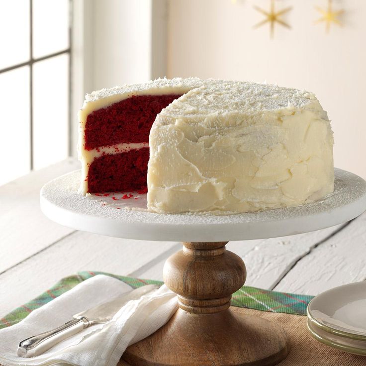 a red velvet cake with white frosting on a plate