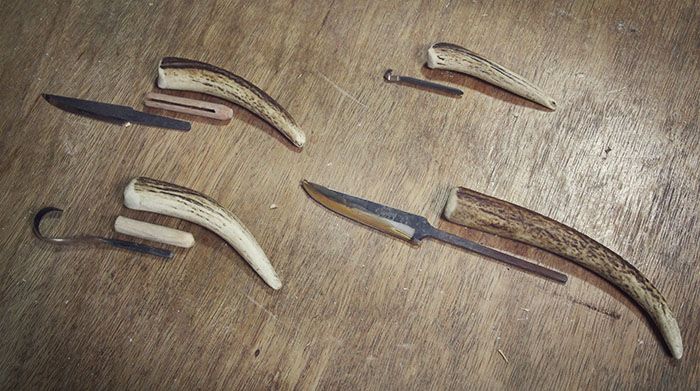 five different types of knives on a wooden table