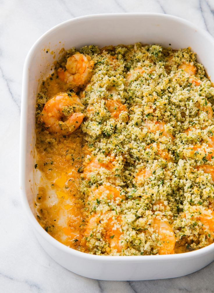 a casserole dish filled with shrimp and cheese