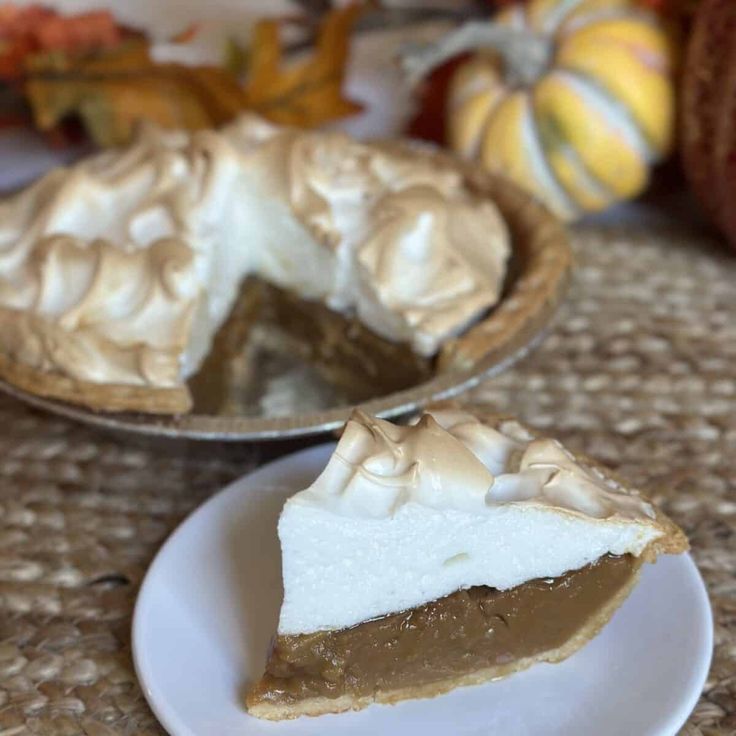 a slice of pie sitting on top of a white plate next to a pie pan