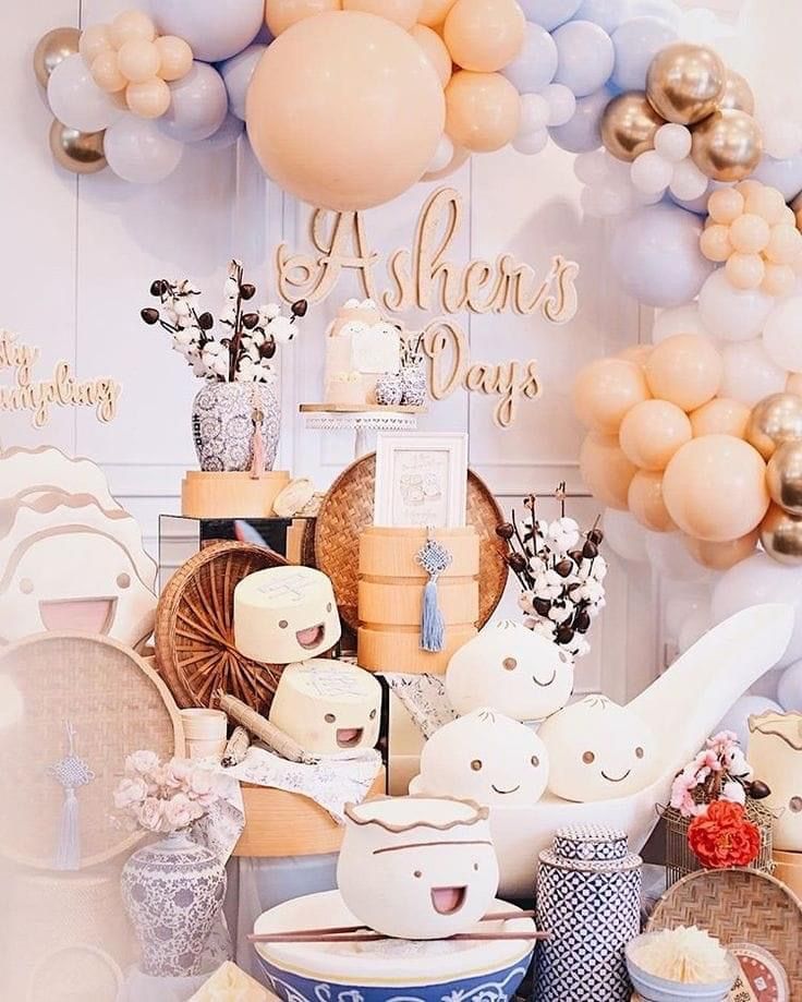 a table topped with lots of plates and balloons