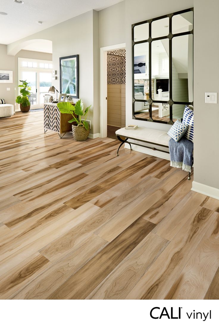 a living room with hardwood floors and mirrors