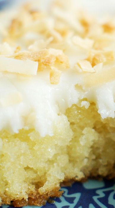 a close up of a piece of cake on a blue and white plate with a bite taken out of it