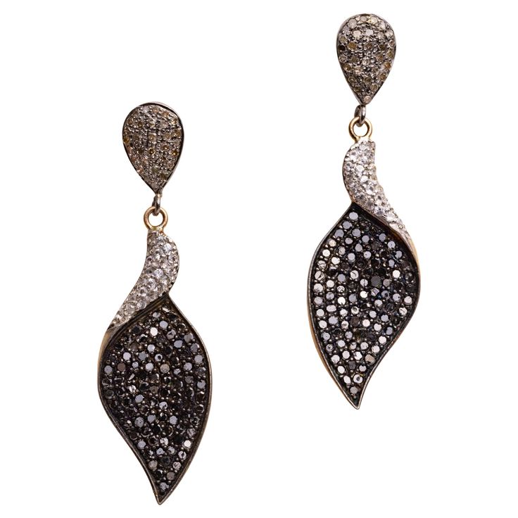 A pair of dangle earrings comprised of black and white diamonds. All are round, brilliant cut diamonds in a pave` setting. Set in sterling silver with an 18K gold post for pierced ears. The fine jewelry collection is sourced, designed or created by Deborah Lockhart Phillips. Through her international travels, she has cultivated prime resources for fine precious and semi-precious gemstones of unusual cuts in a variety of settings. Included in the collection are antique, high 22K gold pieces with intricate workmanship rarely found in the modern age. In creating the contemporary collection, Deborah works directly with artists and craftsmen to bring cutting edge jewelry designs directly to market. Diamonds to Lapis Lazuli, Emeralds to Pearls, and everything in between. Diverse, lovely and vers Pave Setting, Fine Jewelry Collection, Gold Drop Earrings, Precious Gemstones, 22k Gold, White Diamonds, Pierced Ears, Jewelry Designs, Brilliant Cut Diamond