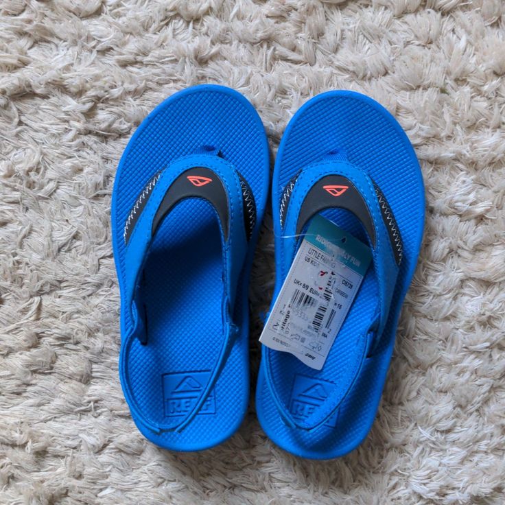 Reef Sandals Size 9/10 Little Fanning Blue Smoke Free Home Blue Round Toe Slippers For Summer, Blue Open Toe Beach Slippers, Blue Non-slip Open Toe Slippers, Casual Blue Non-slip Flip Flops, Blue Non-slip Sandals For Summer, Blue Synthetic Slippers For Vacation, Blue Synthetic Slippers For Beach, Blue Non-slip Flip Flops For Spring, Blue Synthetic Beach Slippers