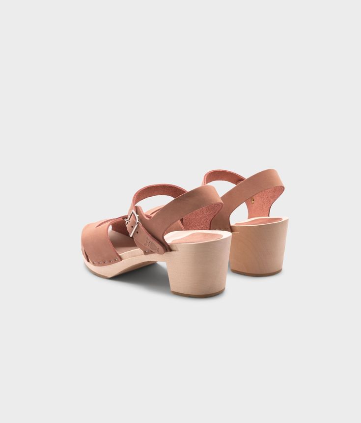 Embrace retro-inspired glamour with our high-heeled clog sandals, complete with an open-toe design that adds a modern twist to a classic silhouette. Perfect for pairing with your favorite dresses or jeans for a chic and stylish look. Clog measurements:Heel height: 2 5/8” (6.5 cm)Toe height: 1 1/2” (3.8 cm) Fit:NarrowLeather:Nubuck leatherClogs consist of:Base: European Lime Wood Sole: Rubber sole Fastening: Staples Other: Metallic buckle Spring Closed Toe Slingback Sandals With Wooden Heel, Chic Closed Toe Slingback Sandals With Heel Loop, Spring Closed-toe Slingback Sandals With Wooden Heel, Chic Summer Clogs With Sculpted Heel, Chic Closed Toe Slingback Sandals With Wooden Heel, Spring Open Toe Clogs With Stacked Heel, Trendy Closed Toe Sandals With Sculpted Heel, Trendy Closed Toe Clogs With Buckle, Trendy Closed Toe Clogs With Buckle Closure