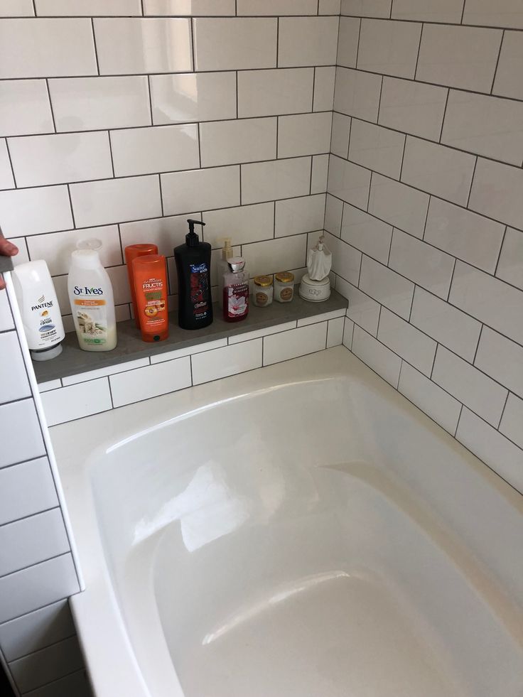 a bathtub with soap, hand sanitizer and lotion bottles