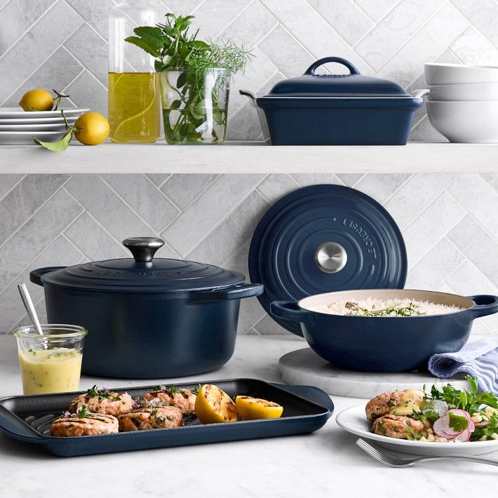 various pots and pans with food in them sitting on the kitchen counter next to each other