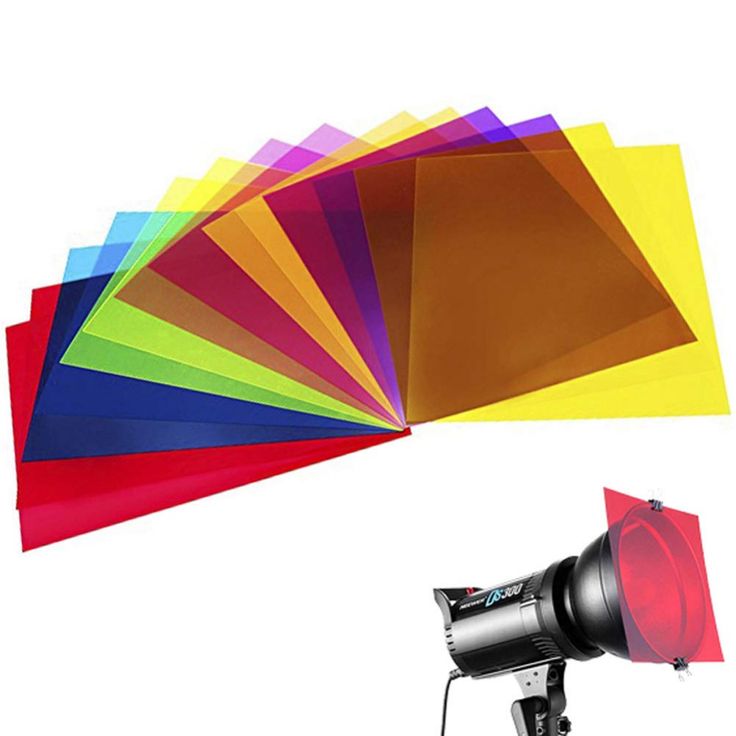 a camera and some different colored sheets on a tripod with a flash light in front of it