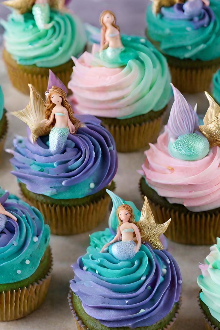 cupcakes decorated with blue, pink and green frosting