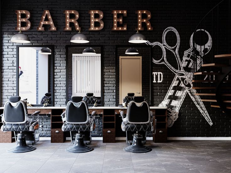 a barber shop with several chairs and scissors on the counter top, in front of a brick wall that says barber